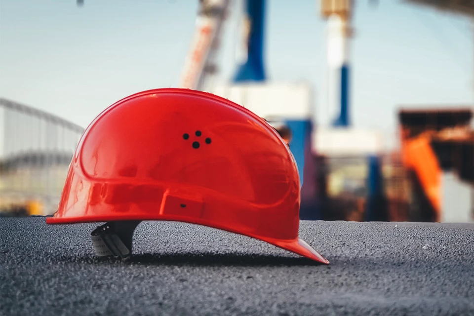 Orange construction hard hat sitting on the ground