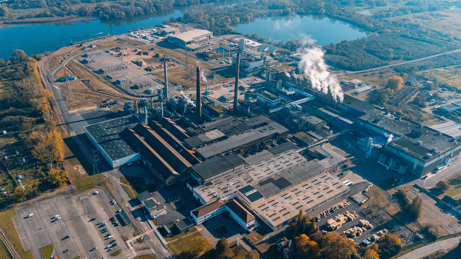 Aerial view of a factory next to a river