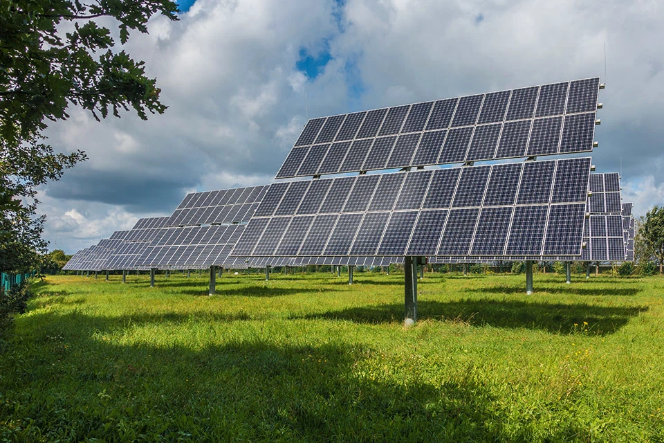 Renewable energy solar panels in a green grass field