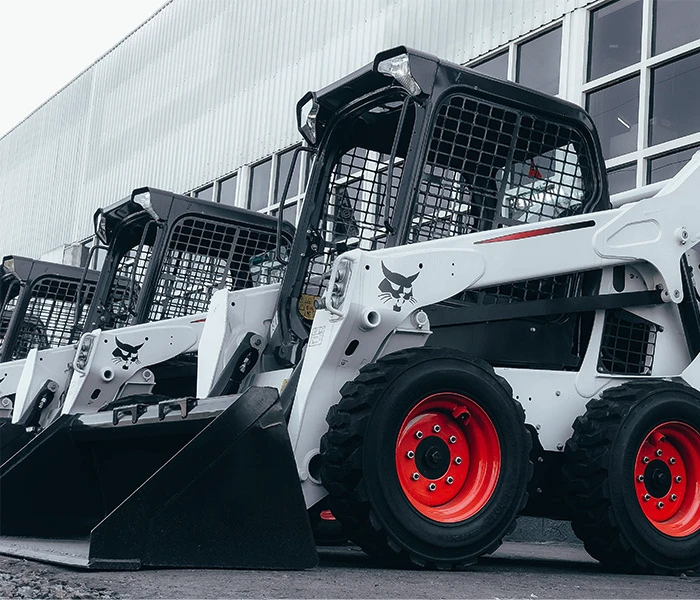 Row of white Bobcat diggers